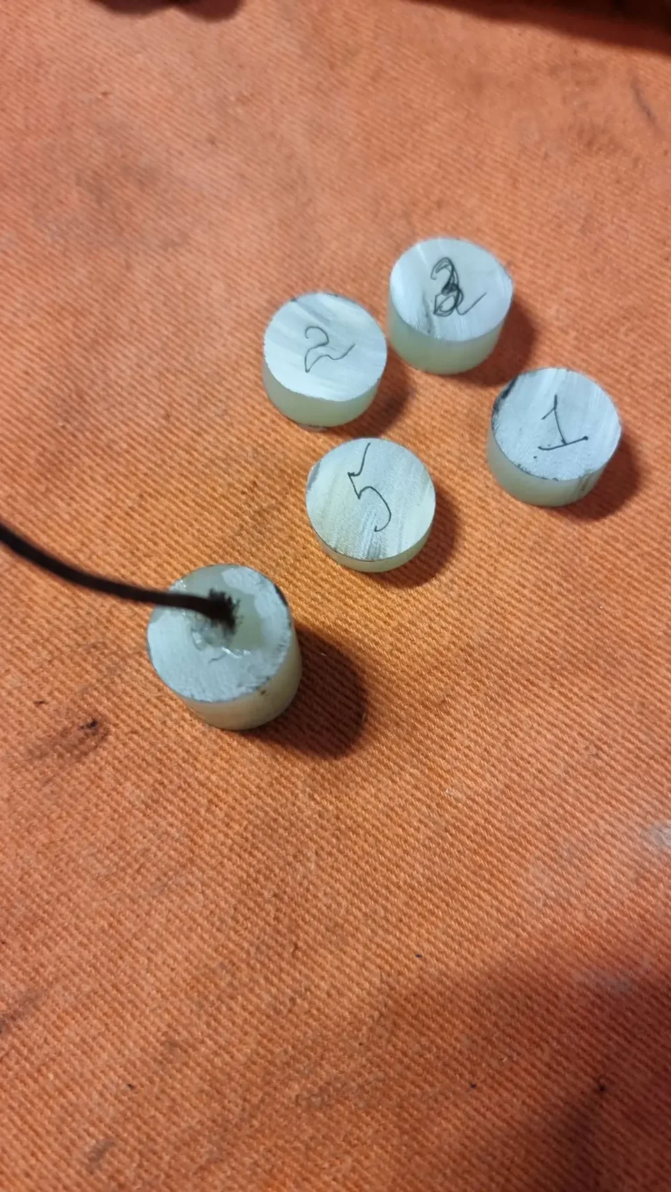 Numbered Garolite samples after the March 2023 burn tests