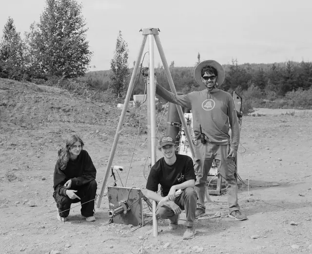 MACH team members working beside the propulsion system